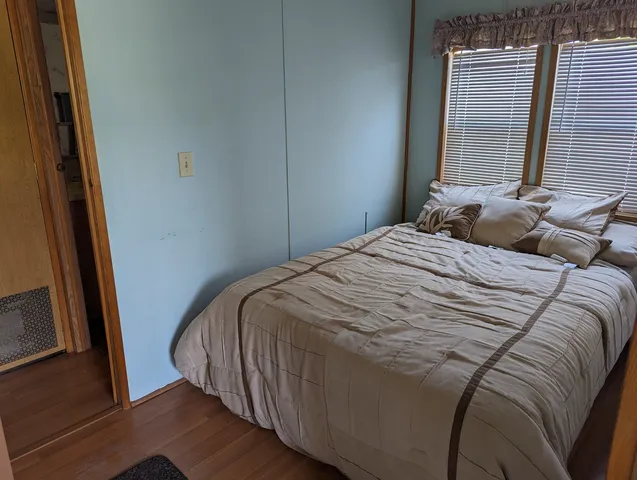 a bedroom with a bed and a mirror
