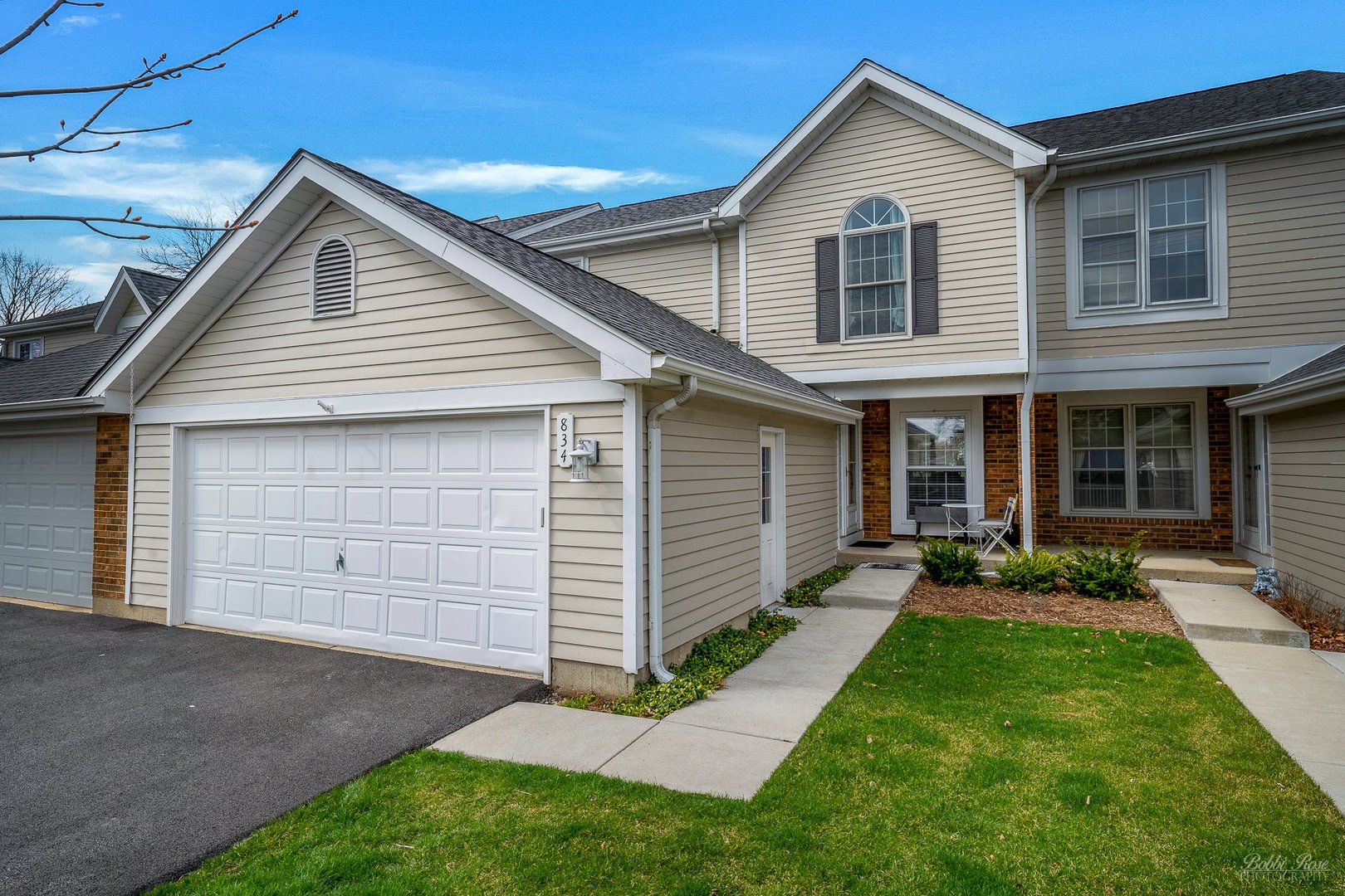 834 Golf Course Road Crystal Lake, IL 60014 - Photo 1 of 40 a front view of a house with a yard and garage