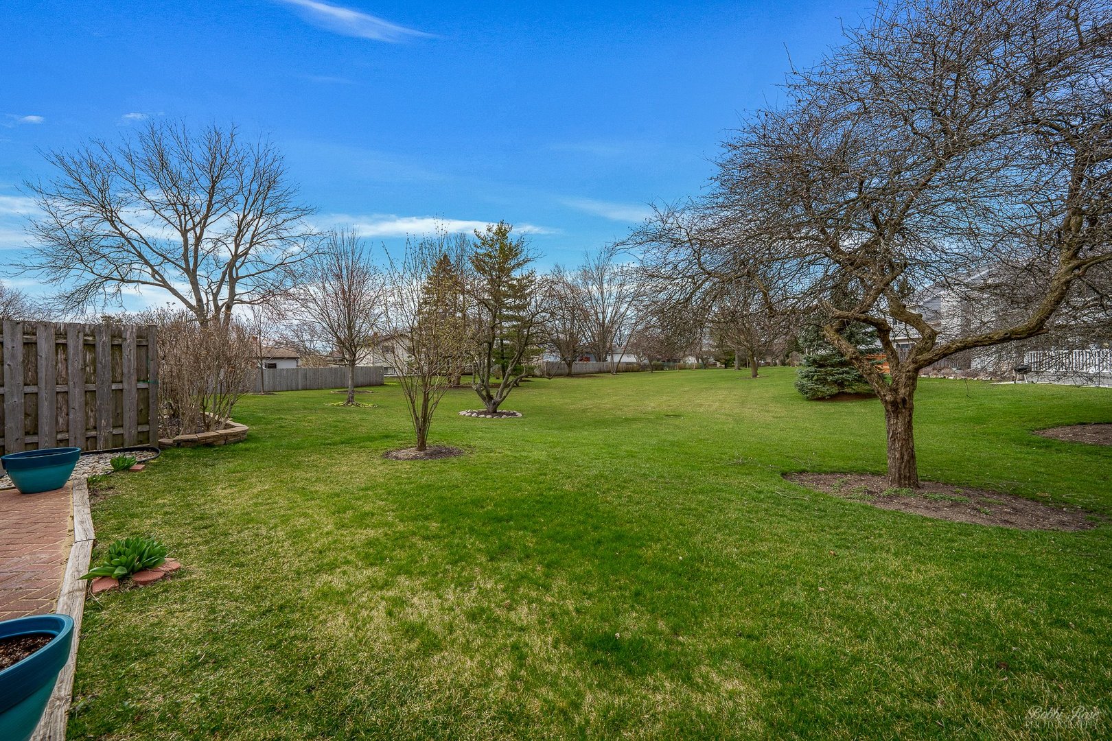 834 Golf Course Road Crystal Lake, IL 60014 - Photo 34 of 40 a backyard of a house with lots of green space