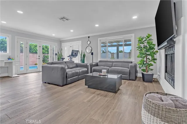 a living room with furniture flat screen tv and a fireplace