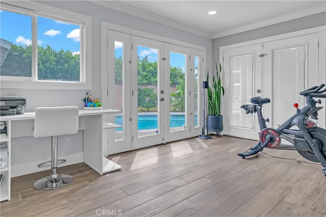 a view of a workspace with furniture and a window