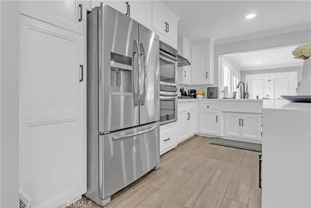 a kitchen with stainless steel appliances a refrigerator sink and cabinets