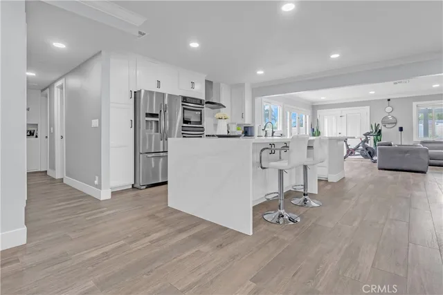 a view of kitchen with refrigerator microwave and wooden floor