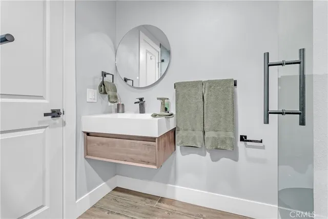 a bathroom with a sink a mirror and a shower
