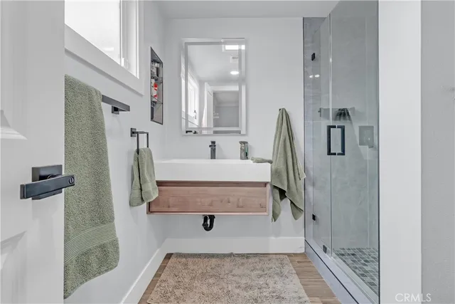 a bathroom with a tub sink and mirror