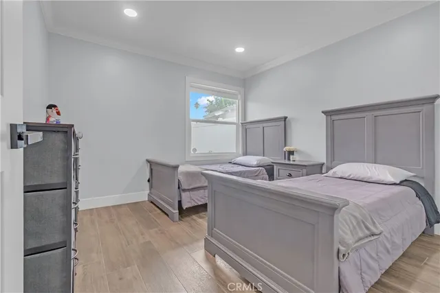 a room with a bed and a refrigerator