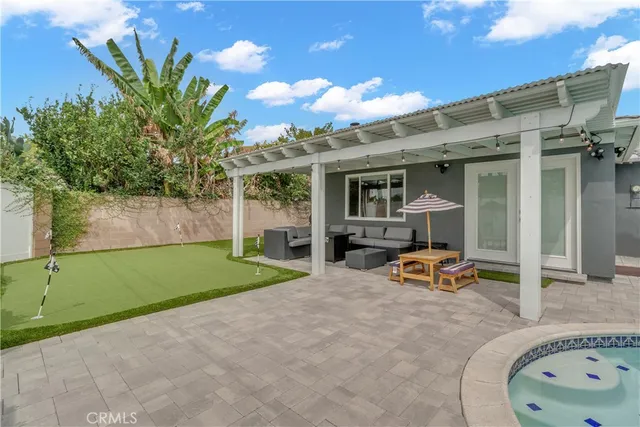 a view of a chair and tables in the patio