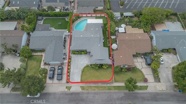 an aerial view of residential house with outdoor space and swimming pool