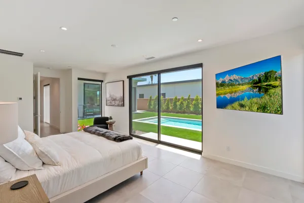 a bedroom with a bed and a painting on the wall
