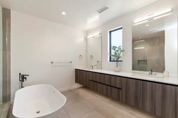 a bathroom with a double vanity sink and a mirror