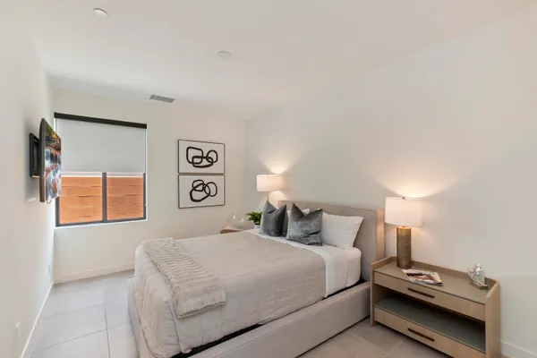 a bedroom with a bed and a night stand