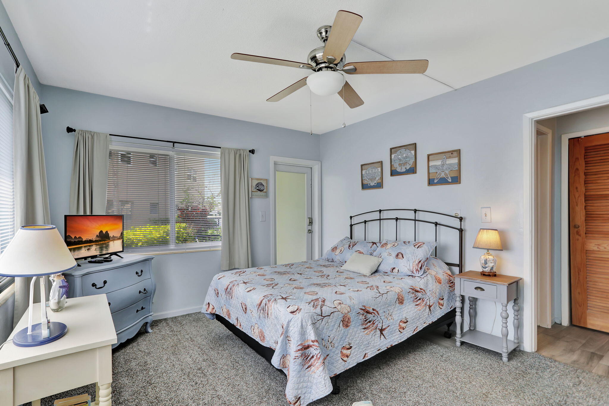 999 North Riverside Drive, Unit 3 Pompano Beach, FL 33062 - Photo 12 of 15 a bedroom with a bed and a flat screen tv