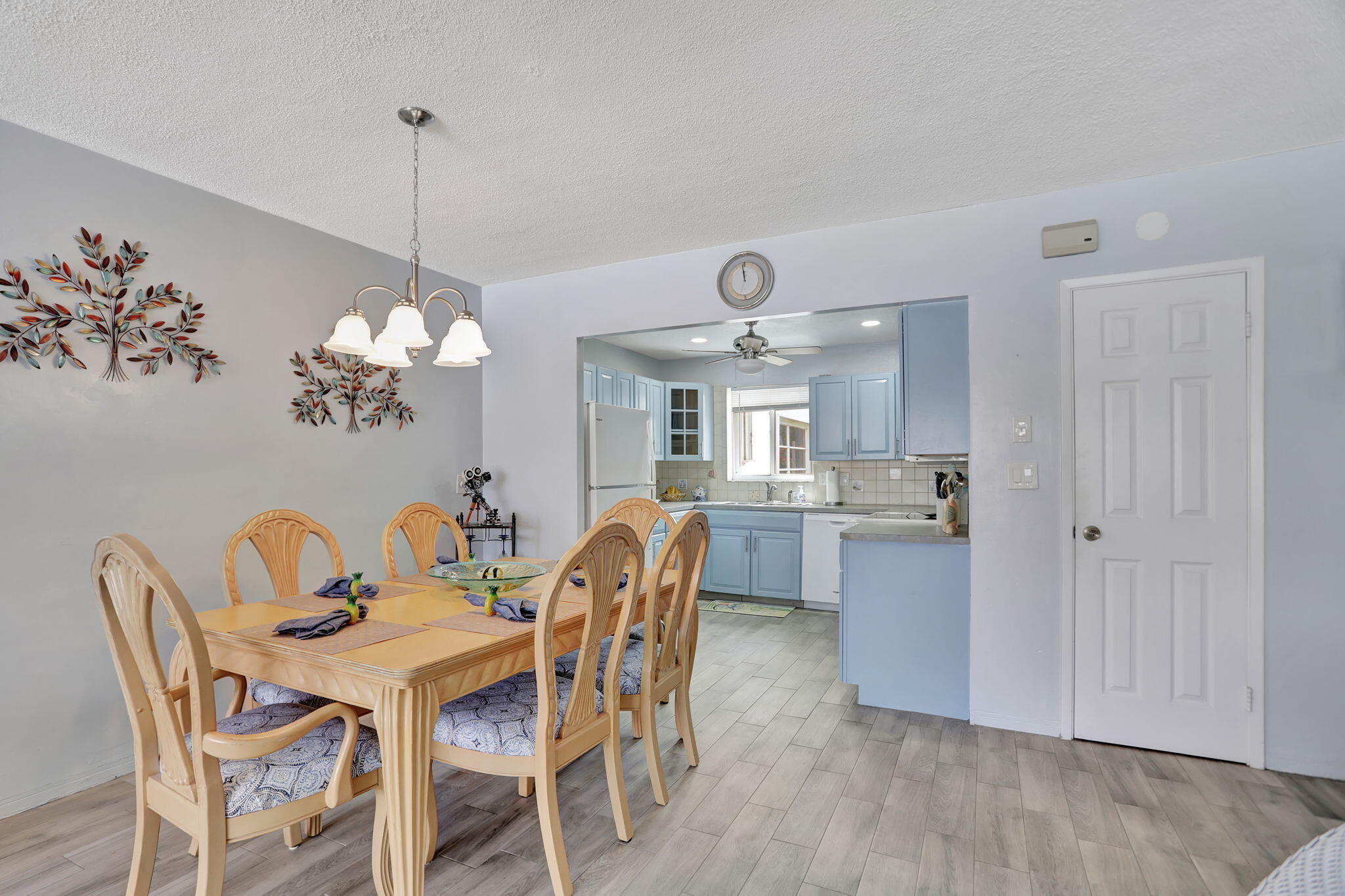 999 North Riverside Drive, Unit 3 Pompano Beach, FL 33062 - Photo 6 of 15 a view of a dining room with furniture wooden floor and chandelier