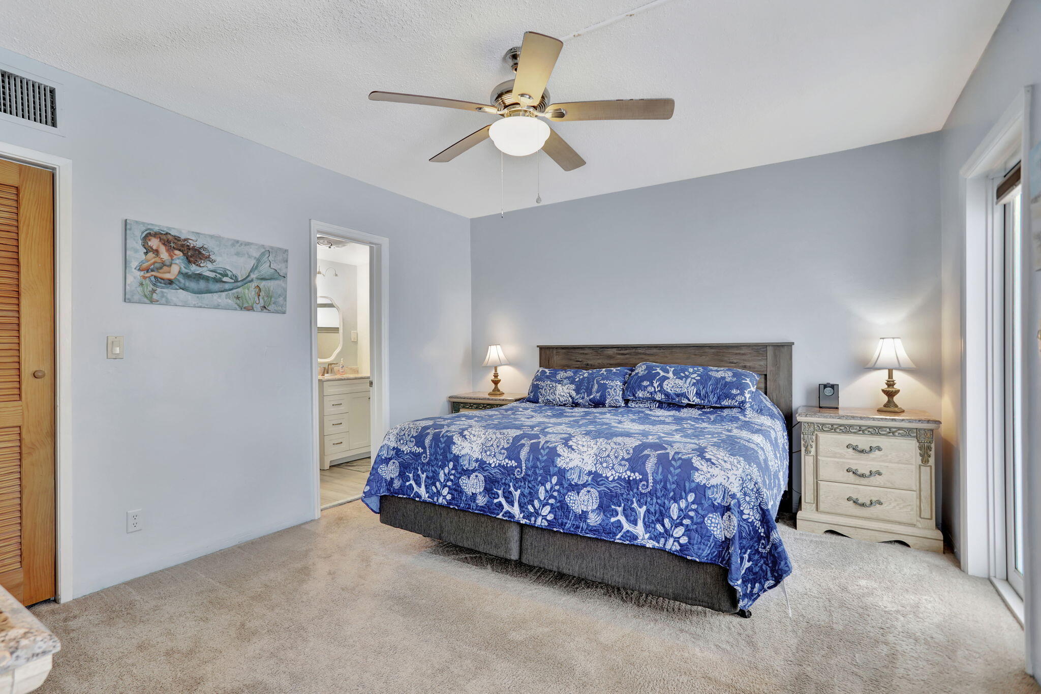 999 North Riverside Drive, Unit 3 Pompano Beach, FL 33062 - Photo 9 of 15 a bedroom with a bed and a chandelier