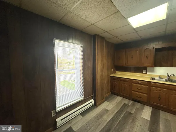 a view of a kitchen with sink cabinets and wooden floor