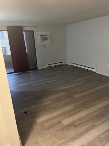 an empty room with wooden floor