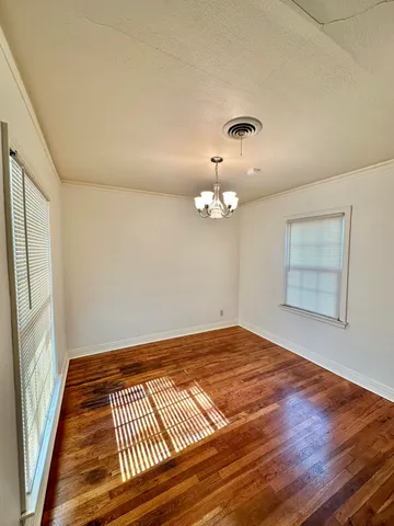 a view of a room with wooden floor and fan
