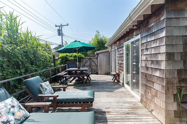 a view of a patio with couches table and chairs and potted plants