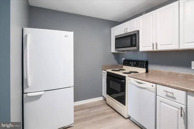 a kitchen with a refrigerator sink and microwave