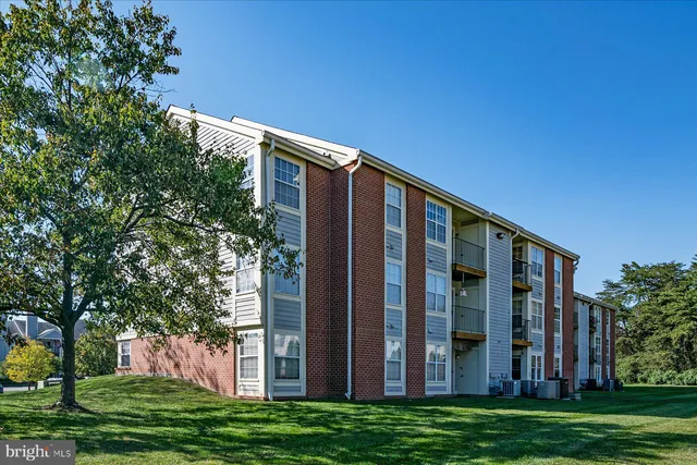 a view of a building with a big yard and plants