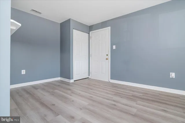 a view of an empty room and wooden floor