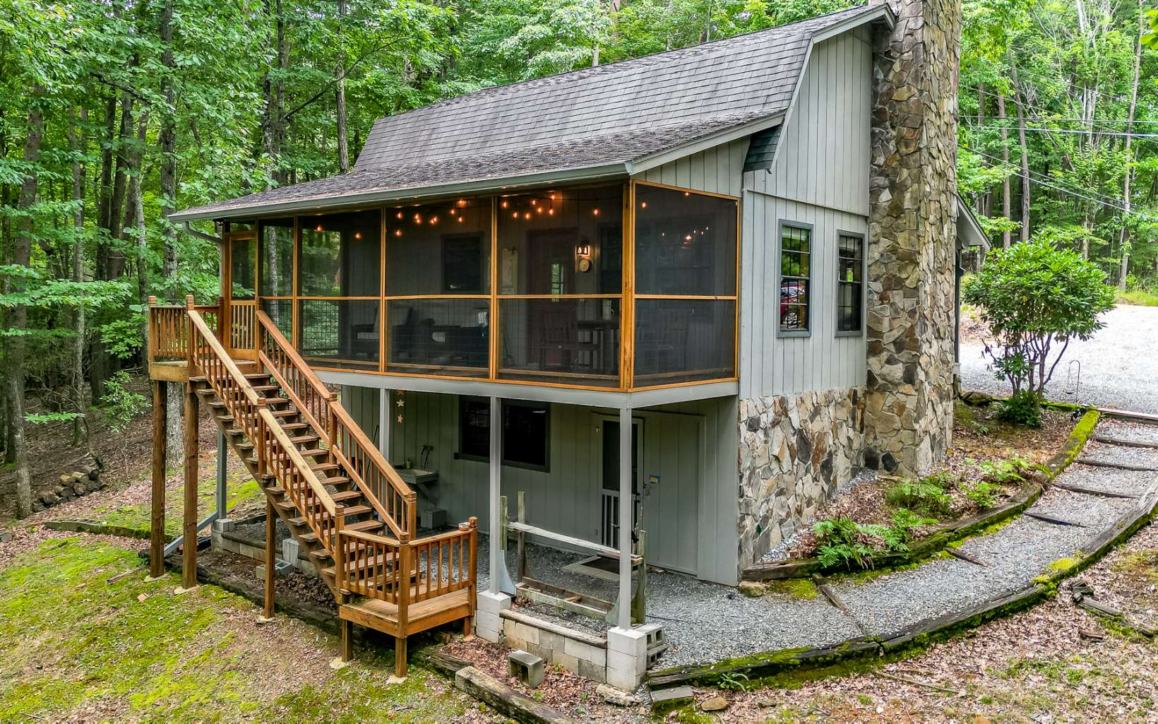 241 Walnut Mountain Road Ellijay, GA 30536 - Photo 2 of 34 a front view of a house with a garden