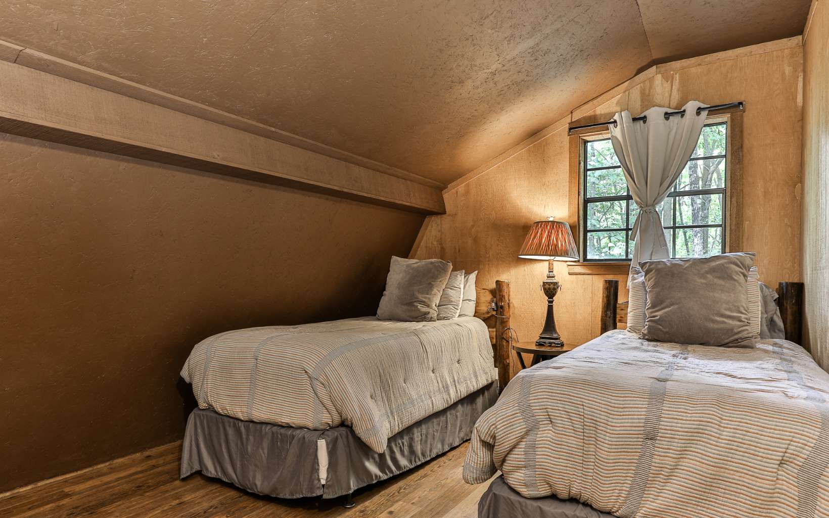 241 Walnut Mountain Road Ellijay, GA 30536 - Photo 22 of 34 a bedroom with two beds and painting on the wall