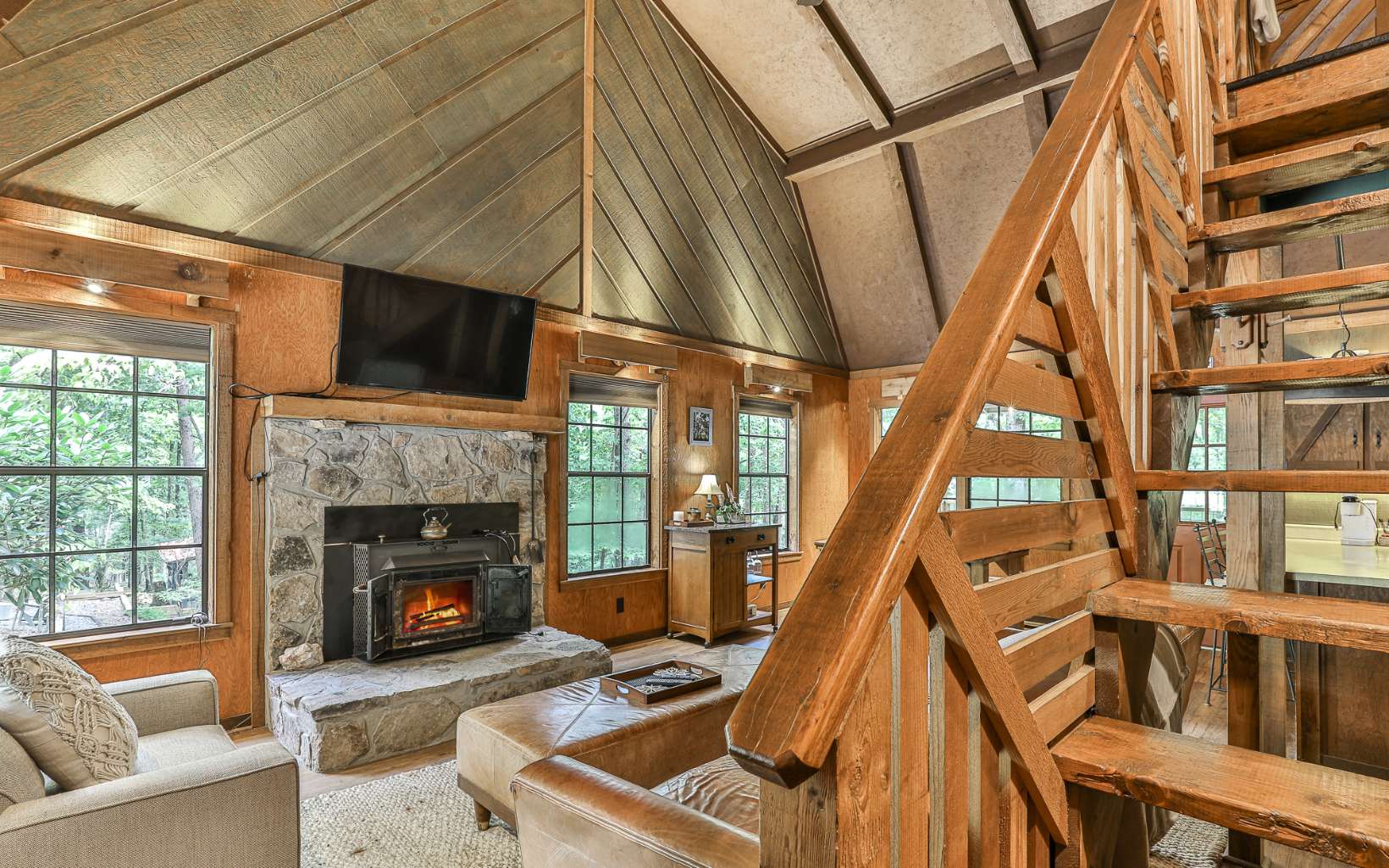 241 Walnut Mountain Road Ellijay, GA 30536 - Photo 10 of 34 a living room with a fireplace furniture and a floor to ceiling window