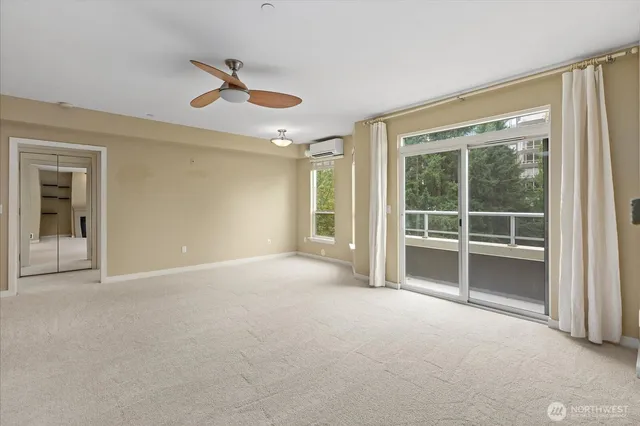 a view of an empty room with a fireplace and a large window