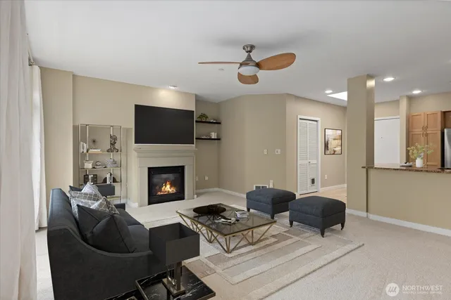 a living room with furniture a fireplace with projector screen