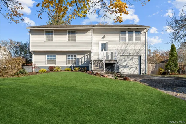 a view of a house with a yard and sitting area