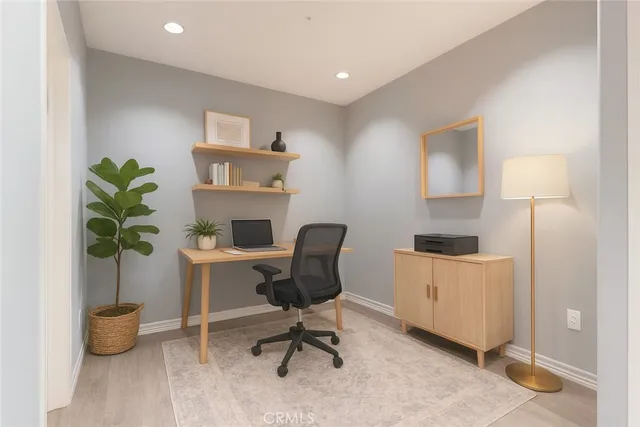 a workspace with furniture and a potted plant