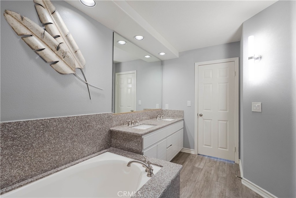 2233 Martin, Unit 108 Irvine, CA 92612 - Photo 13 of 34 a bathroom with a tub sink and mirror