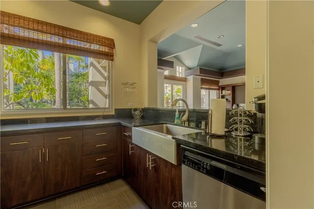 a kitchen with a sink and large windows