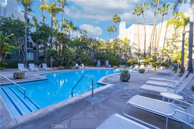 a swimming pool with outdoor seating and yard