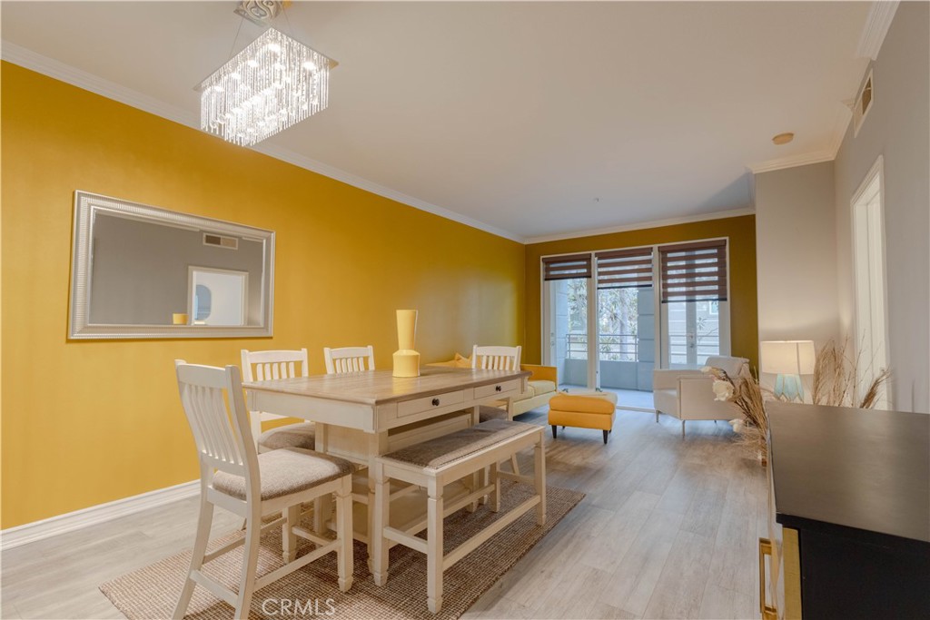 2233 Martin, Unit 108 Irvine, CA 92612 - Photo 3 of 34 a dining room with a table chairs and wooden floor