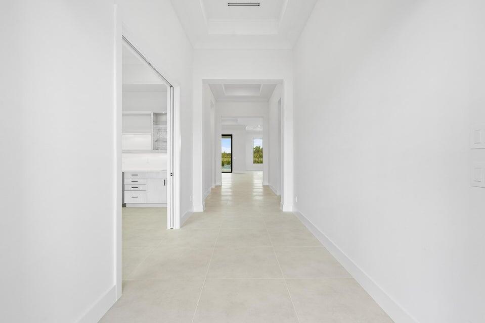 170 Southeast Rio Angelica Port St. Lucie, FL 34984 - Photo 18 of 55 a view of a hallway with wooden shelves