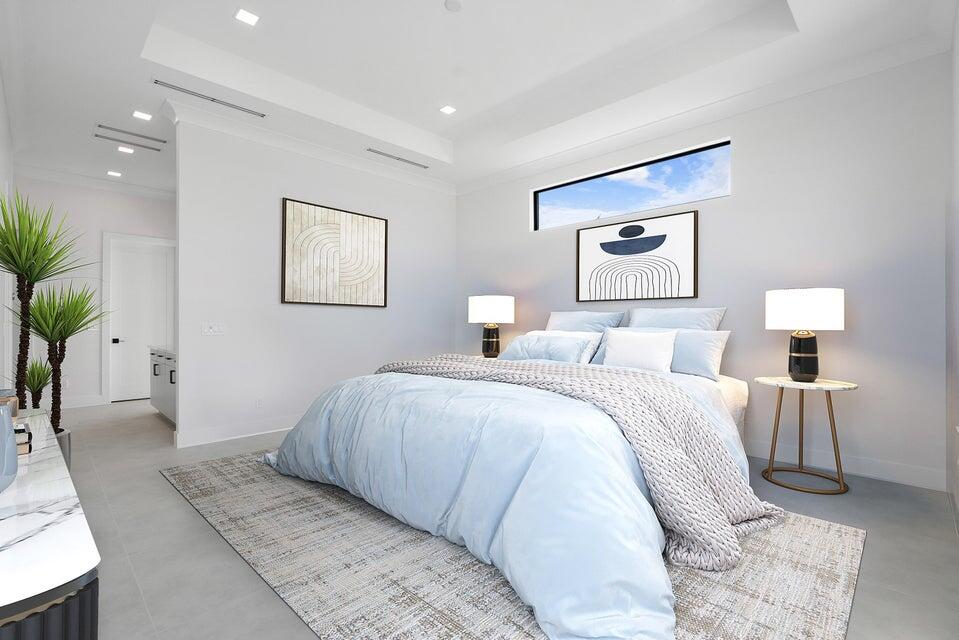 170 Southeast Rio Angelica Port St. Lucie, FL 34984 - Photo 26 of 55 a bedroom with a large bed and a potted plant