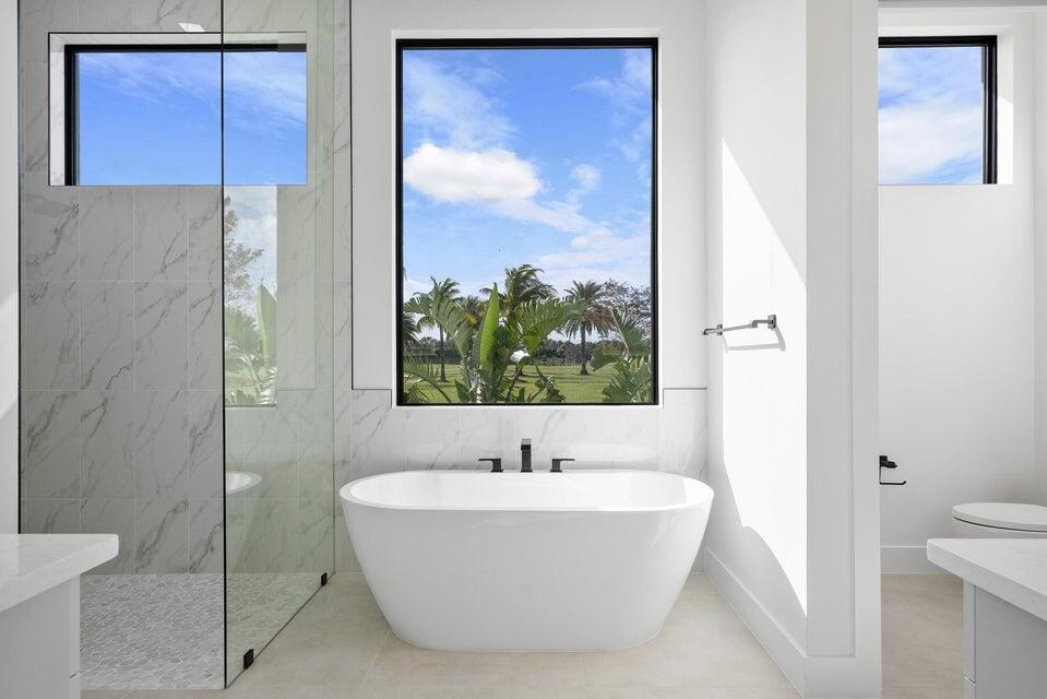 170 Southeast Rio Angelica Port St. Lucie, FL 34984 - Photo 30 of 55 a white bath tub sitting next to a bathroom sink