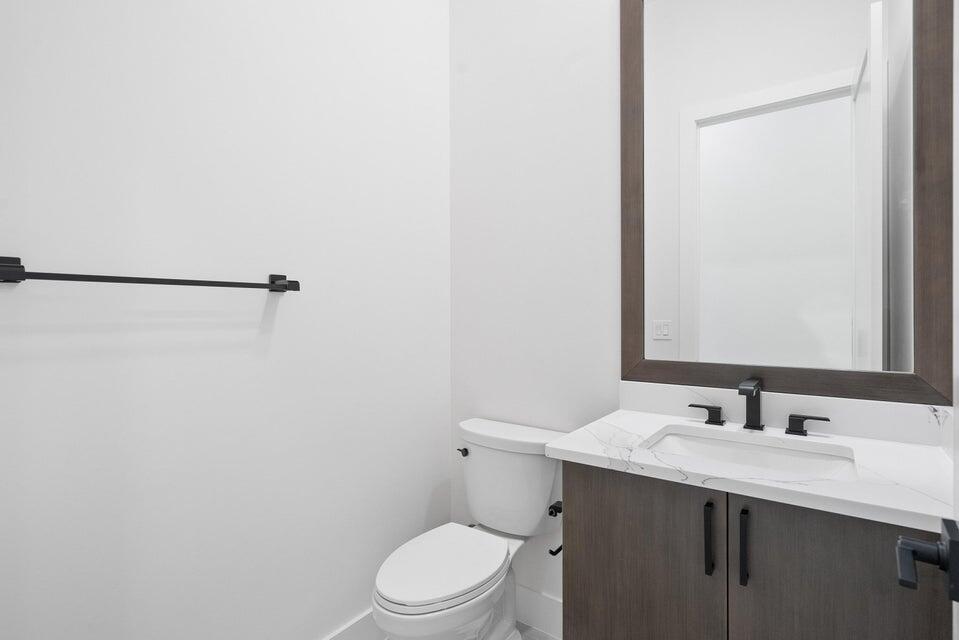 170 Southeast Rio Angelica Port St. Lucie, FL 34984 - Photo 39 of 55 a bathroom with a sink mirror vanity and toilet