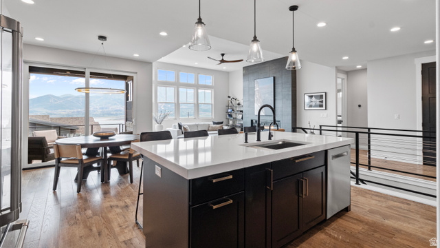 355 East Overlook Loop Hideout, UT 84036 - Photo 12 of 40 Kitchen island featuring a white countertop, undermount sink, and black cabinetry