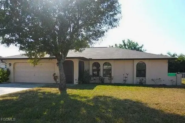 a view of a house with yard and a tree