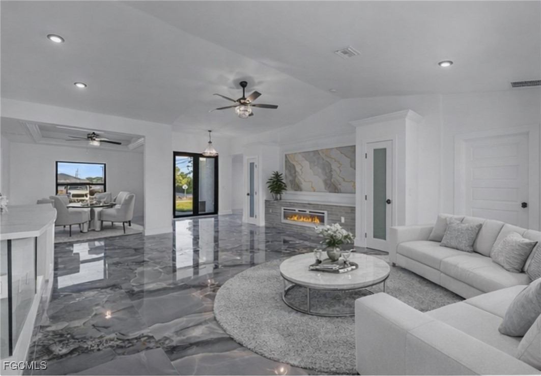 2901 2nd Street Southwest Lehigh Acres, FL 33976 - Photo 12 of 40 a living room with furniture and a dining table with kitchen view