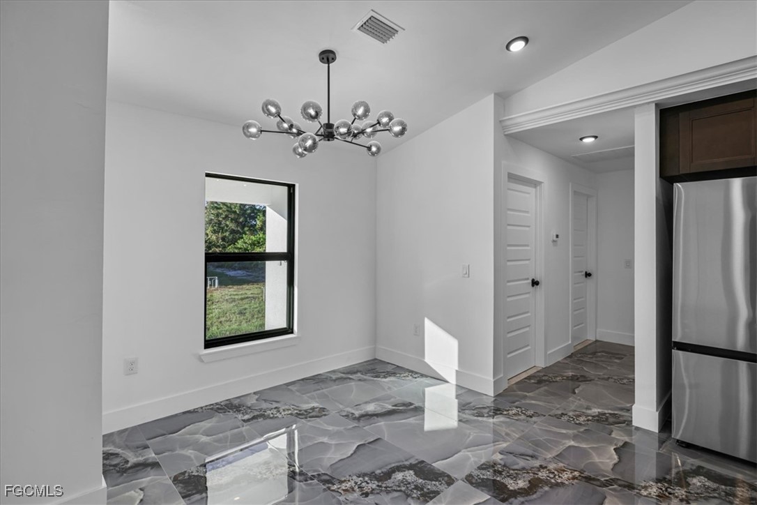 2901 2nd Street Southwest Lehigh Acres, FL 33976 - Photo 17 of 40 a view of a hallway with a chandelier