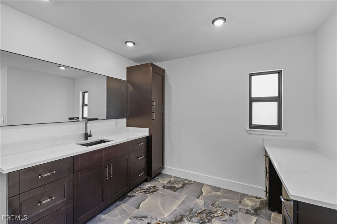 2901 2nd Street Southwest Lehigh Acres, FL 33976 - Photo 26 of 40 a bathroom with a sink and a mirror