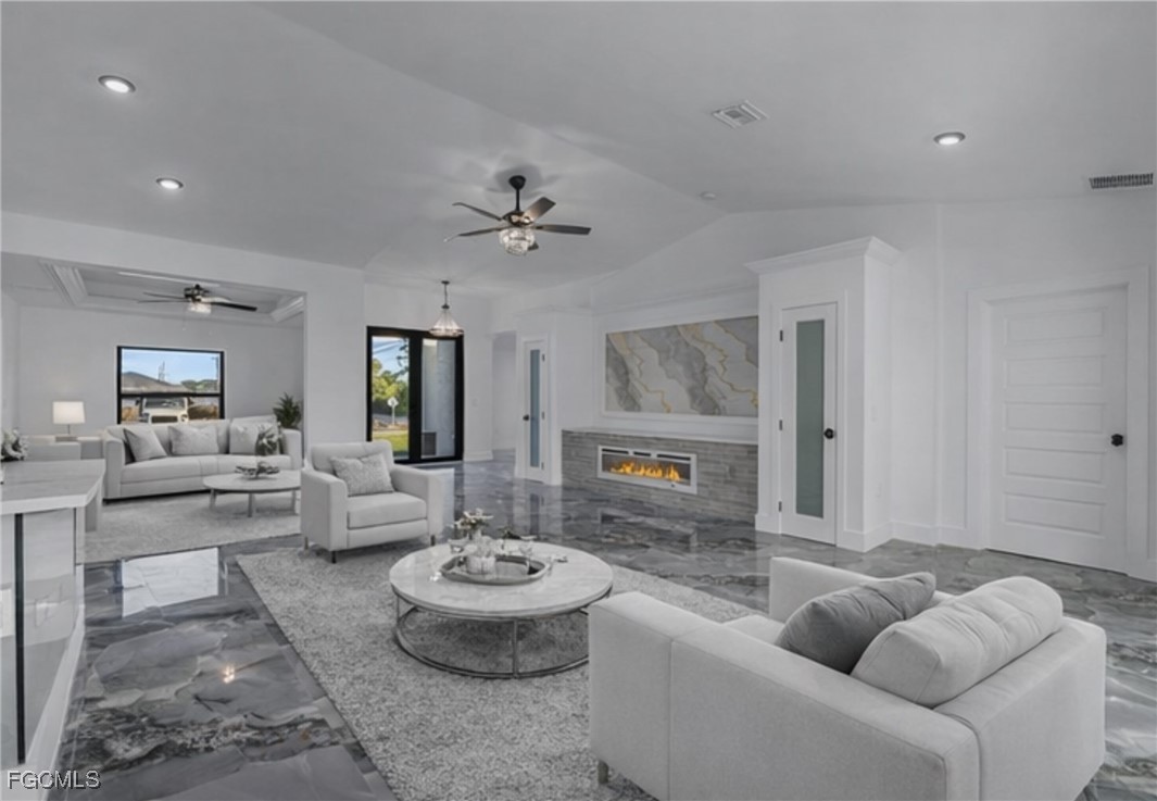 2901 2nd Street Southwest Lehigh Acres, FL 33976 - Photo 9 of 40 a living room with furniture and a large window