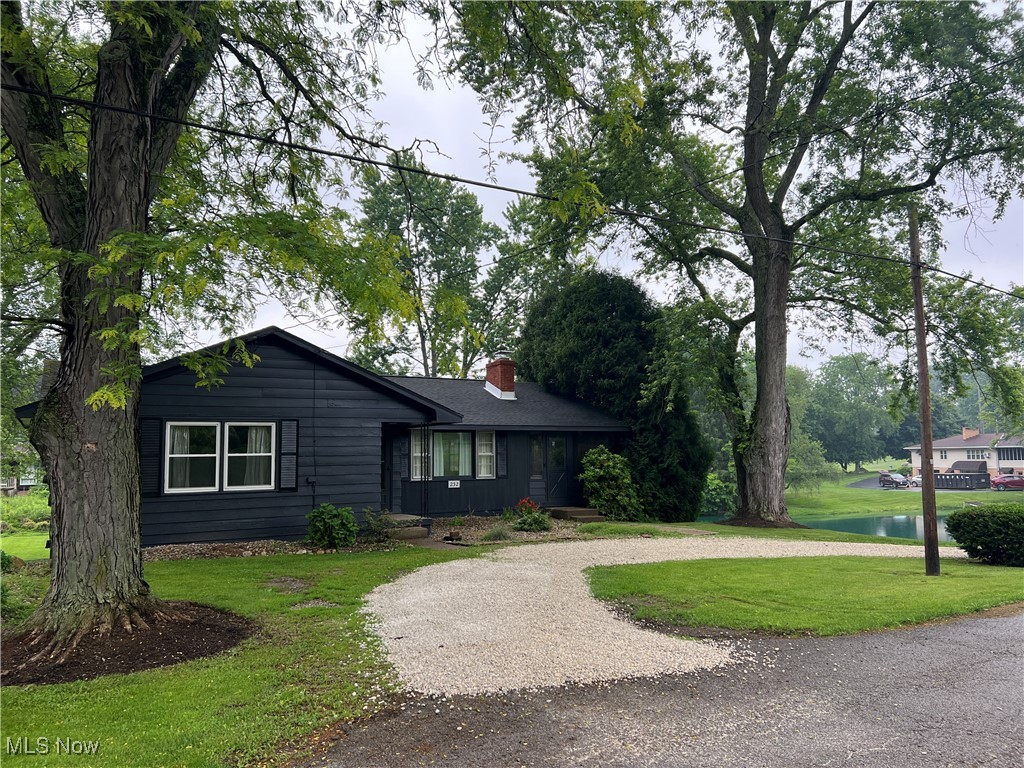 232 Hoffman Road Loudonville, OH 44842 - Photo 14 of 28 Ranch-style house with a chimney, curved driveway, a front lawn, and a water view