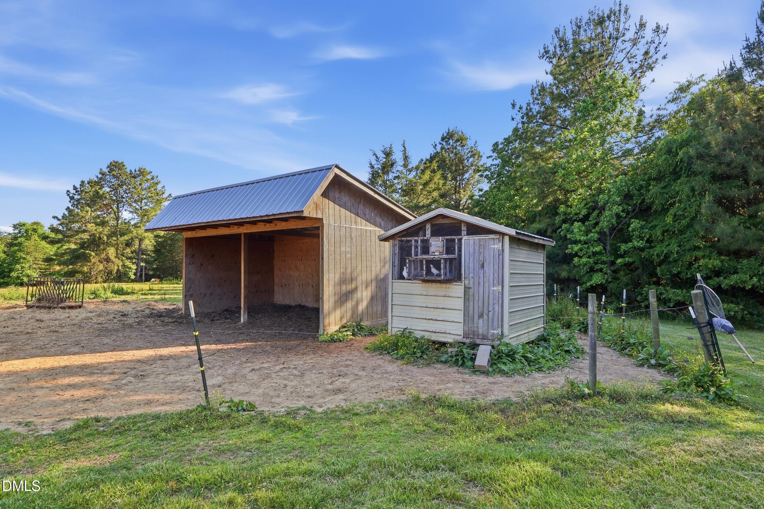 2631 South Jim Minor Road Haw River, NC 27258 - Photo 51 of 62 a house with green field in front of it