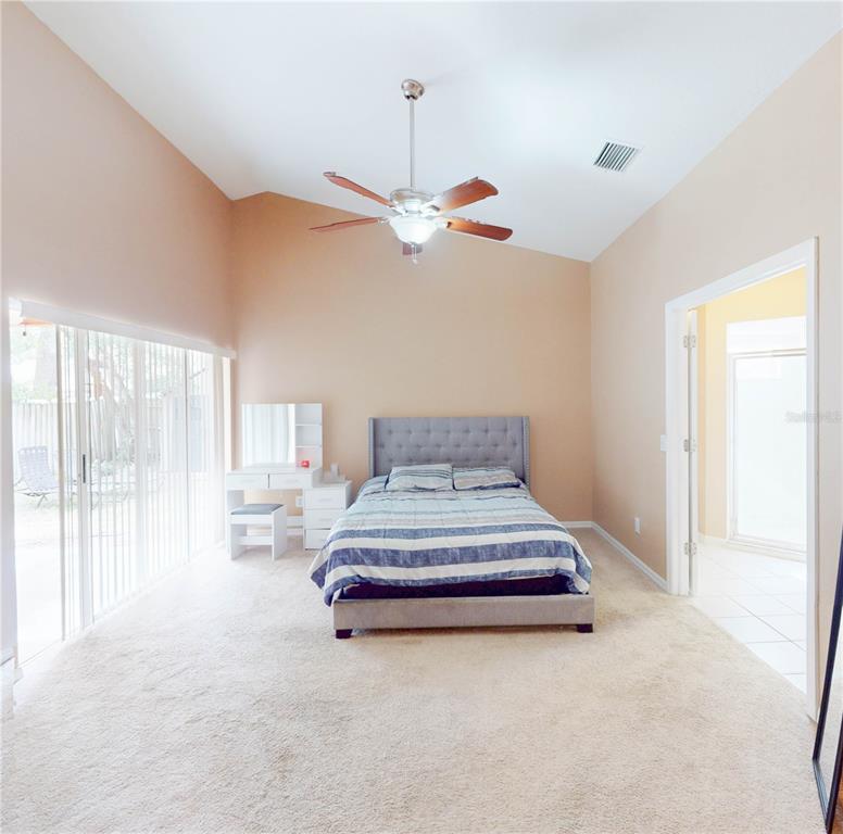 1103 Mallory Point Drive Valrico, FL 33596 - Photo 7 of 21 a spacious bedroom with a bed and ceiling fan