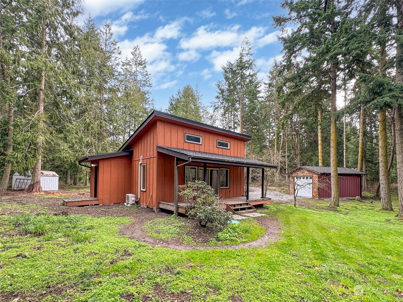 253 Sylvan Ridge Road Sequim, WA 98382 - Photo 1 of 40 a front view of house with yard and trees in the background